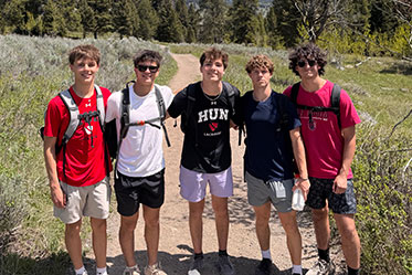 Five students standing on a trail together. Links to Beneficiary Designations