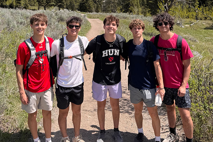 Five students standing on a trail together. Links to Beneficiary Designations